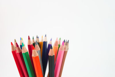 Close-up of colored pencils against white background