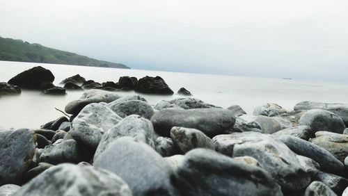 Rocks in sea against sky