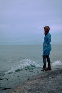 Man standing on beach against sky