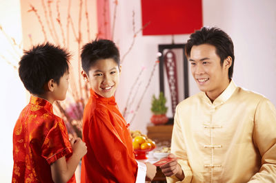 Father greeting sons during festival