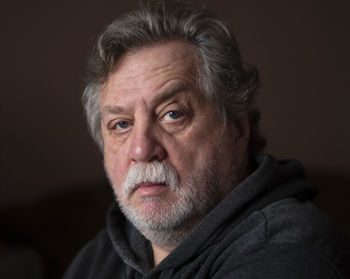 Portrait of man against black background