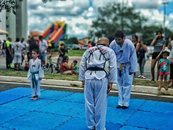 People in park against blue sky