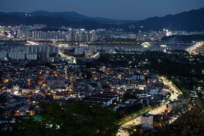 High angle view of illuminated city buildings at night