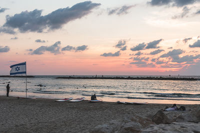 Scenic view of beach against sky during sunset