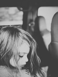 Close-up of girl sitting in car