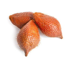 Close-up of orange fruit against white background