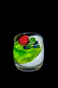 Close-up of fruits in glass against black background