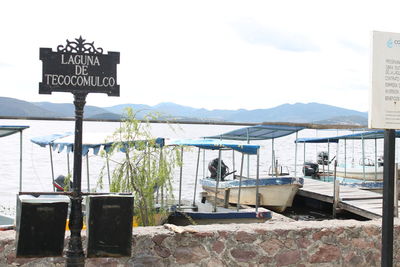 Information sign on mountain against clear sky