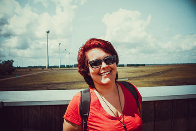 Portrait of smiling man wearing sunglasses against sky