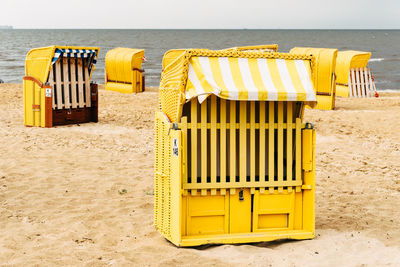Sandy beach and typical hooded beach chairs in cuxhaven in the north sea coast a cloudy day  summer