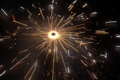 Low angle view of firework display at night
