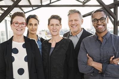 Portrait of multi-ethnic confident business people standing at office