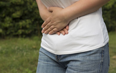 Midsection of couple standing against blurred background