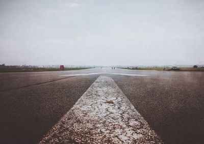 Empty road along trees