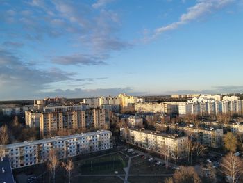 High angle view of buildings by river against sky