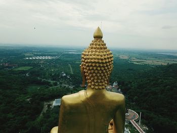 Statue of temple against building