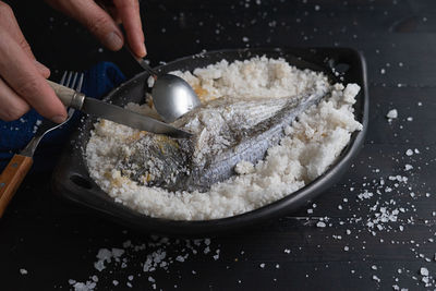 Midsection of person preparing food in kitchen