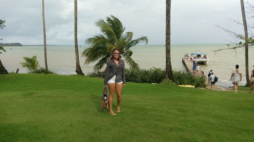 Rear view of people standing on palm tree