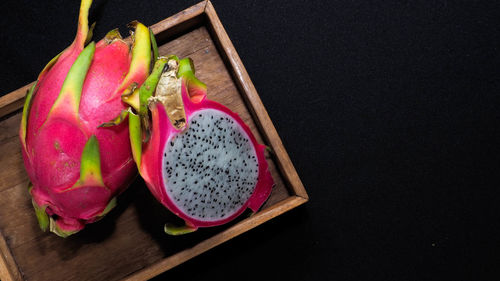 High angle view of fruits on table against black background