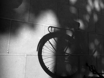 High angle view of bicycle shadow on tiled floor