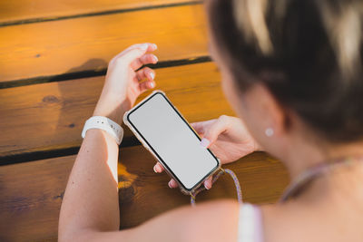 Midsection of woman using mobile phone