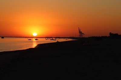 Scenic view of sea against orange sky