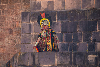 Statue against brick wall