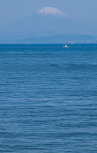 Scenic view of sea against blue sky