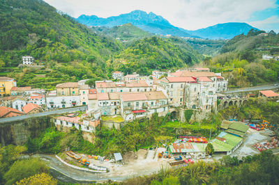 High angle view of townscape and mountains against sky