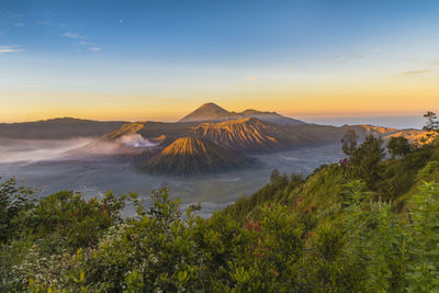 Scenic view of volcanic landscape against sky during sunset