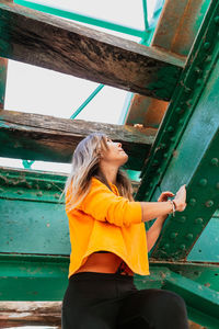 Side view of a young woman standing outdoors