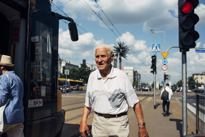 Man standing on street in city