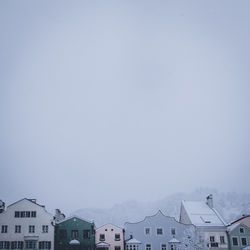 Houses against clear sky during winter