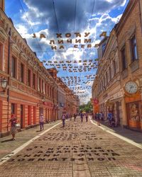 People walking on street amidst buildings in town