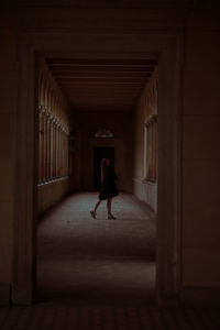 Woman walking in corridor of building