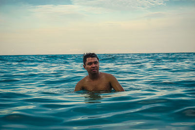 Portrait of shirtless man in swimming pool