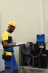 Rear view of man working at construction site