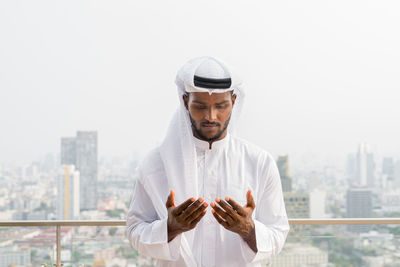 Portrait of man standing against clear sky