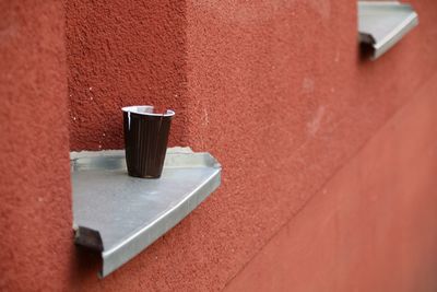 Close-up of coffee on table against wall