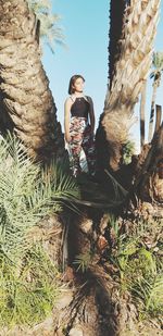 Woman standing by plants