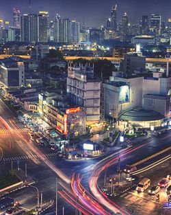 High angle view of illuminated city street and buildings at night