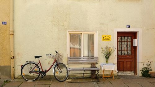 Bicycle against yellow wall of building