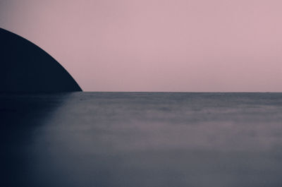 Scenic view of sea against clear sky during sunset