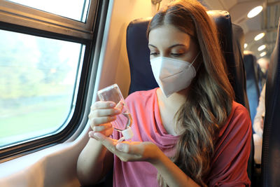 Close-up of woman sitting in train