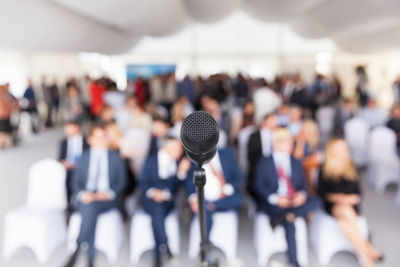 Close-up of microphone with business people sitting in background during seminar
