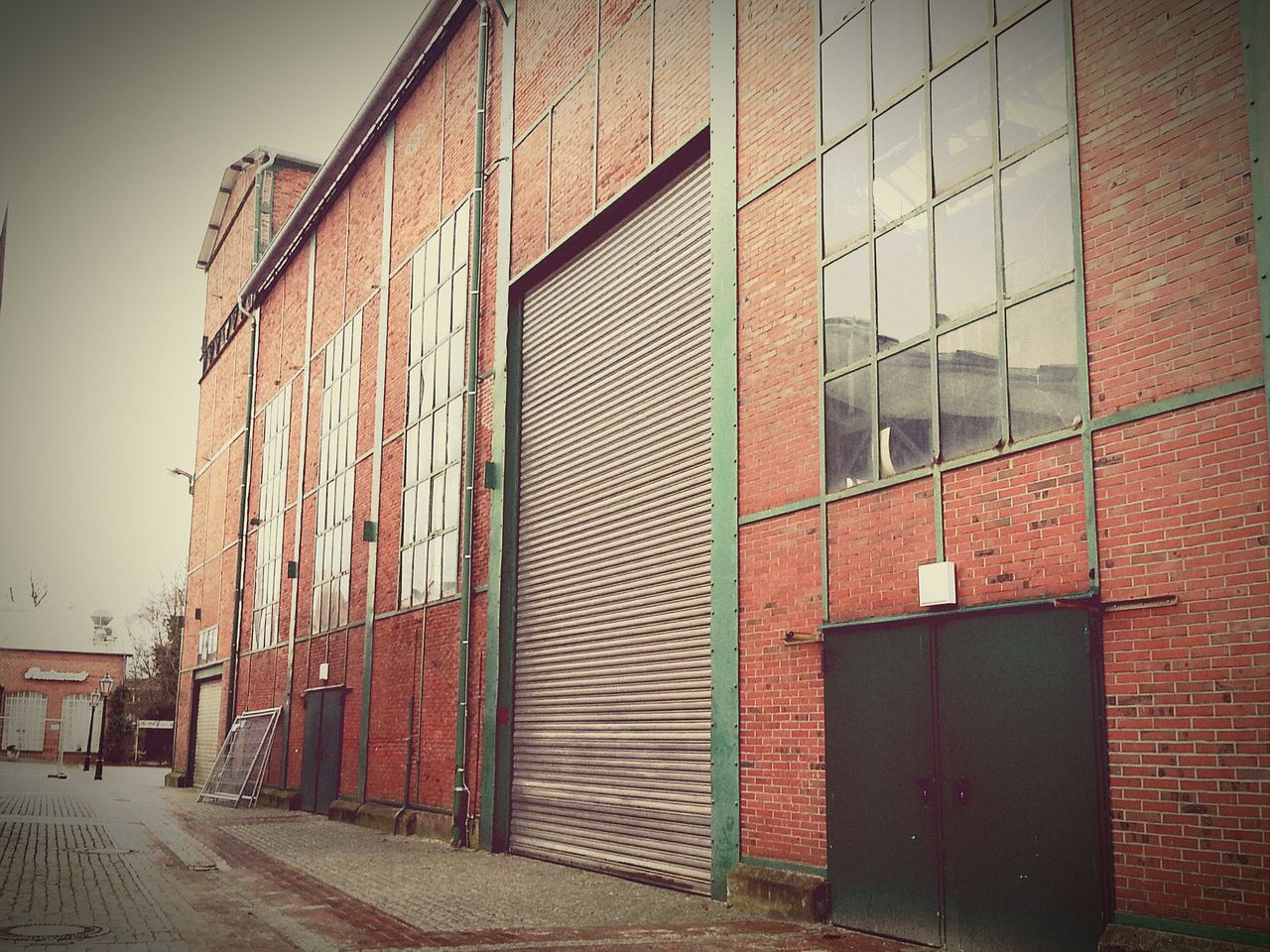 building exterior, architecture, built structure, street, window, building, city, residential structure, residential building, road, wall - building feature, transportation, day, outdoors, house, red, brick wall, sidewalk, no people, wall