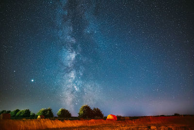 Scenic view of field against sky at night