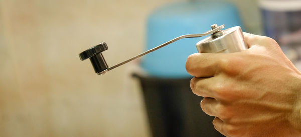 Close-up of hand holding pepper mill