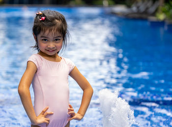 Portrait of cute girl standing in water