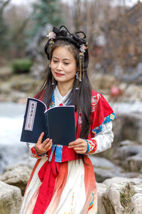 Portrait of young woman using digital tablet